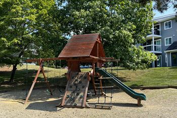 a playground with a swing set and a slide at Deercross Apartments, Ohio, 45236